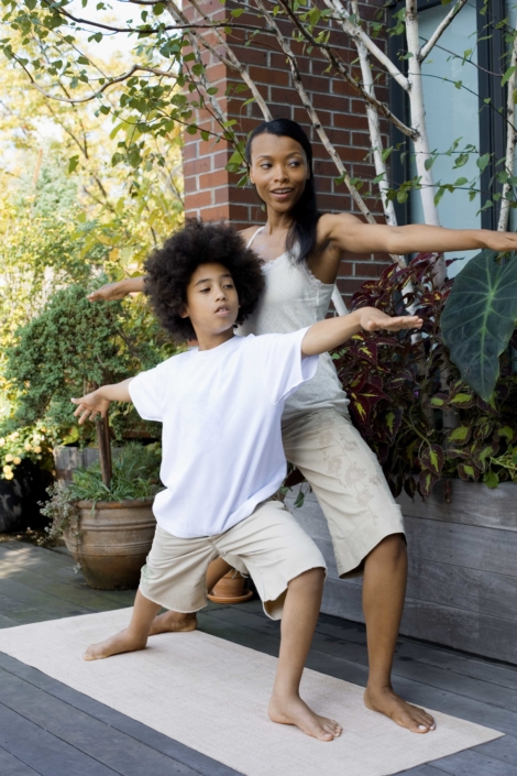 Mother and son exercising together outdoors